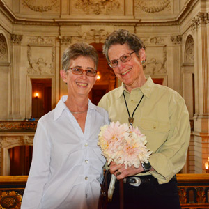 Author and partner holding wedding bouquet