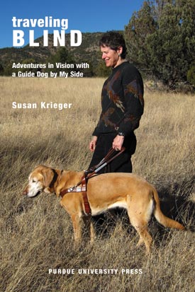 Cover image of Traveling Blind showing author led by her guide dog through a field of golden grasses