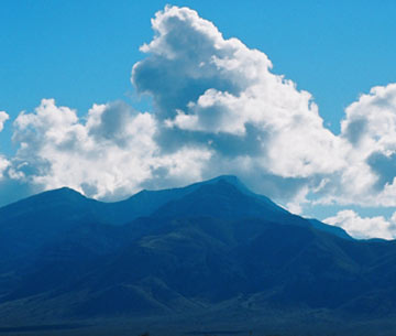 Photo of Big Hatchet Mountain with bright clouds above